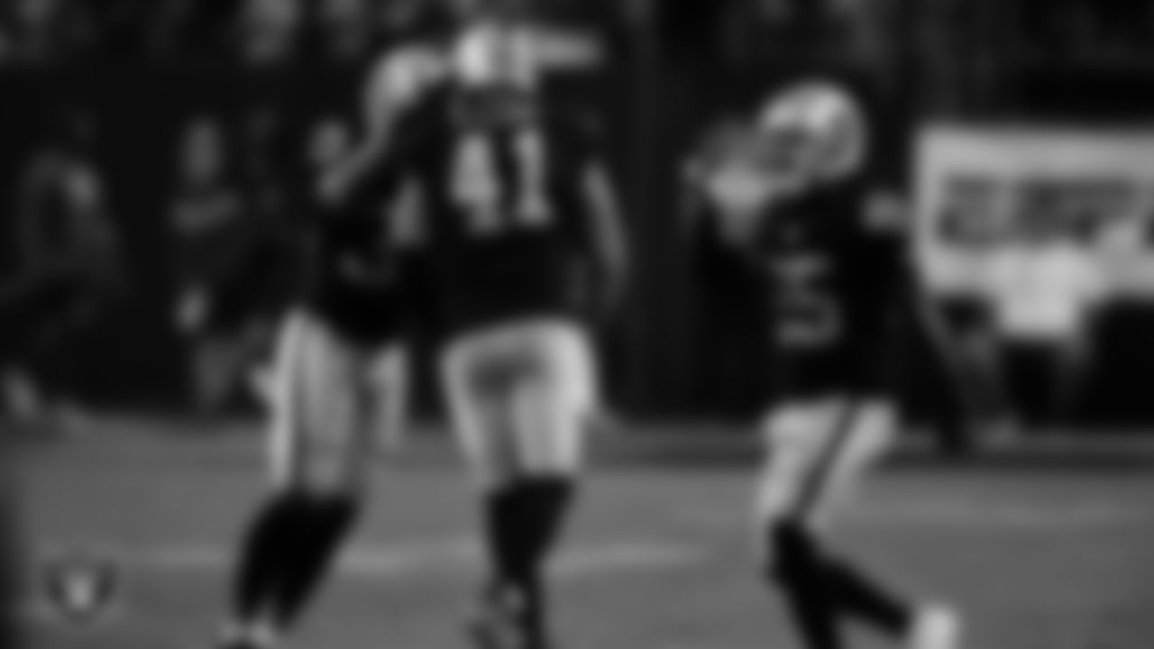 Las Vegas Raiders linebacker Robert Spillane (41) is congratulated on his second interception during the regular season home game against the Green Bay Packers at Allegiant Stadium.