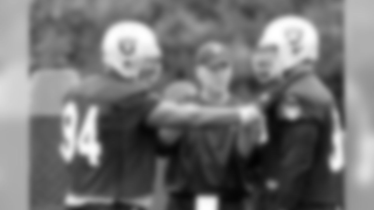 Defensive line coach Mike Waufle offers some instruction. Photo by Tony Gonzales.