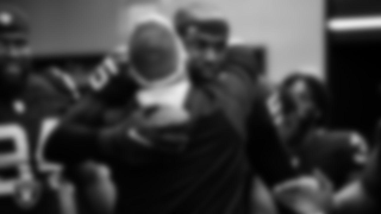 Las Vegas Raiders Head Coach Josh McDaniels and defensive end Chandler Jones (55) in the locker room after the regular season home game against the New England Patriots at Allegiant Stadium.
