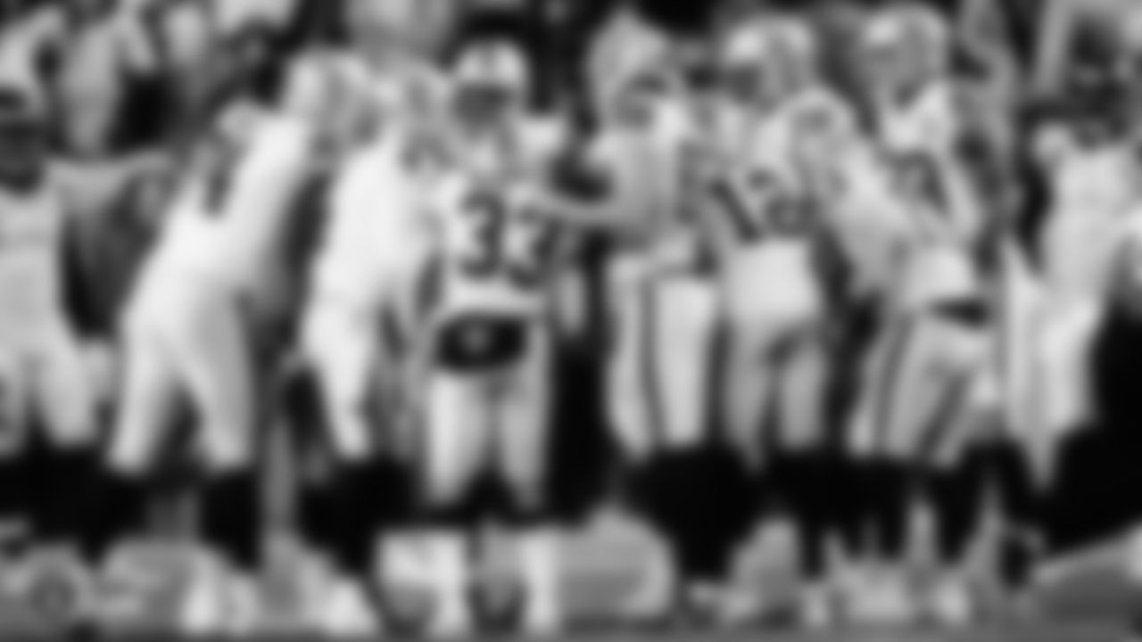 The Raiders huddle during the regular season game against the Denver Broncos.