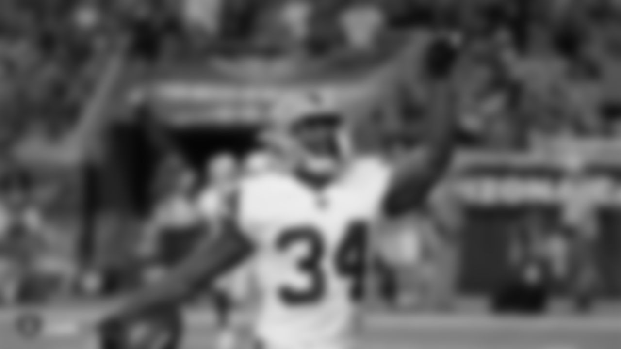 Raiders running back Mack Brown (34) celebrates after rushing for a 3-yard touchdown during the Raiders preseason game against the Arizona Cardinals.