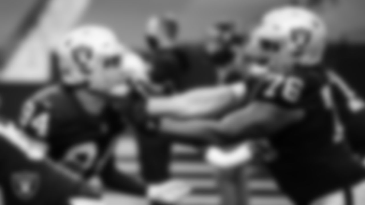 Las Vegas Raiders defensive end Carl Nassib (94) and guard John Simpson (76) warming up before the regular season home game against the Tampa Bay Buccaneers.