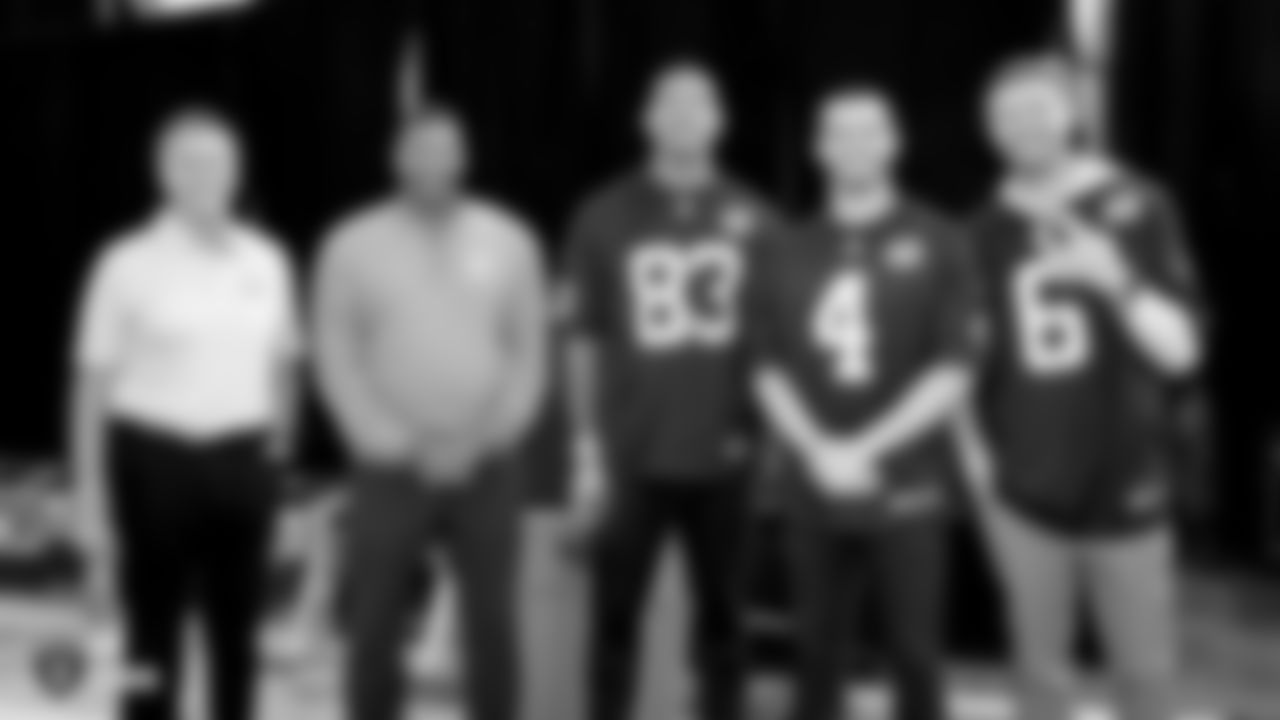 Raiders alumni Jim Plunkett and Napoleon McCallum pose for a photo with tight end Darren Waller (83), quarterback Derek Carr (4) and punter AJ Cole (6) before an official announcement of the Raiders changing their name to the Las Vegas Raiders.