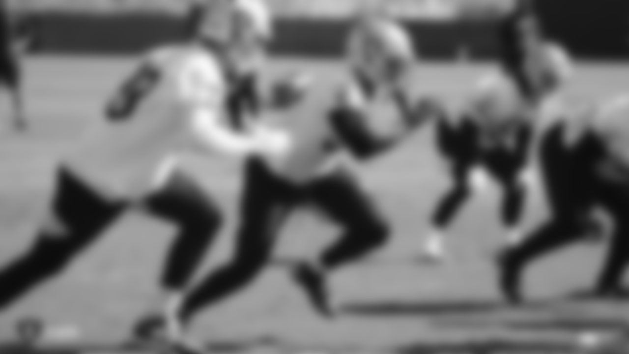 Oakland Raiders defensive end Maxx Crosby (98) and defensive end Kendall Donnerson (57) rush the quarterback during practice.