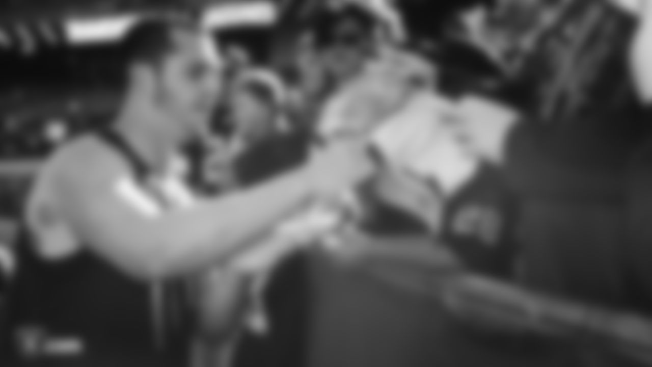 Raiders quarterback Derek Carr (4) signs autographs for fans before the regular season game against the Jacksonville Jaguars.