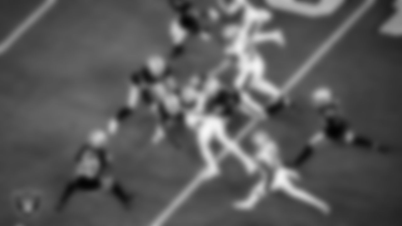 Las Vegas Raiders linebacker Cory Littleton (42) and safety Johnathan Abram (24) make a tackle during the regular season home game against the New Orleans Saints.