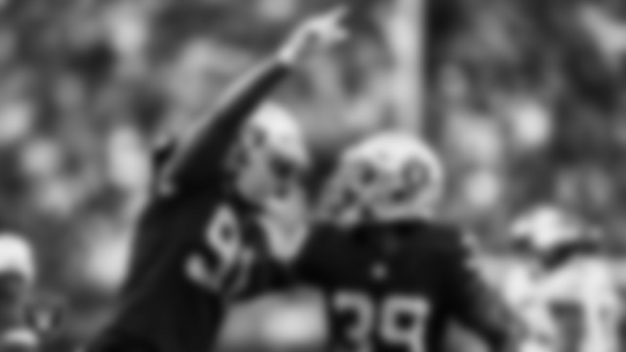 Las Vegas Raiders defensive end Yannick Ngakoue (91) and cornerback Nate Hobbs (39) celebrate during the regular season home game against the Philadelphia Eagles.