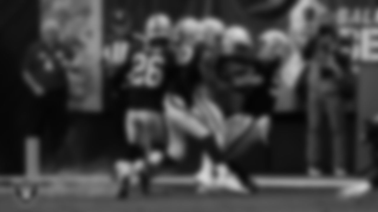 Las Vegas Raiders defensive end Maxx Crosby (98) and linebacker Jayon Brown (50) make a tackle during the regular season home game against the Indianapolis Colts at Allegiant Stadium.