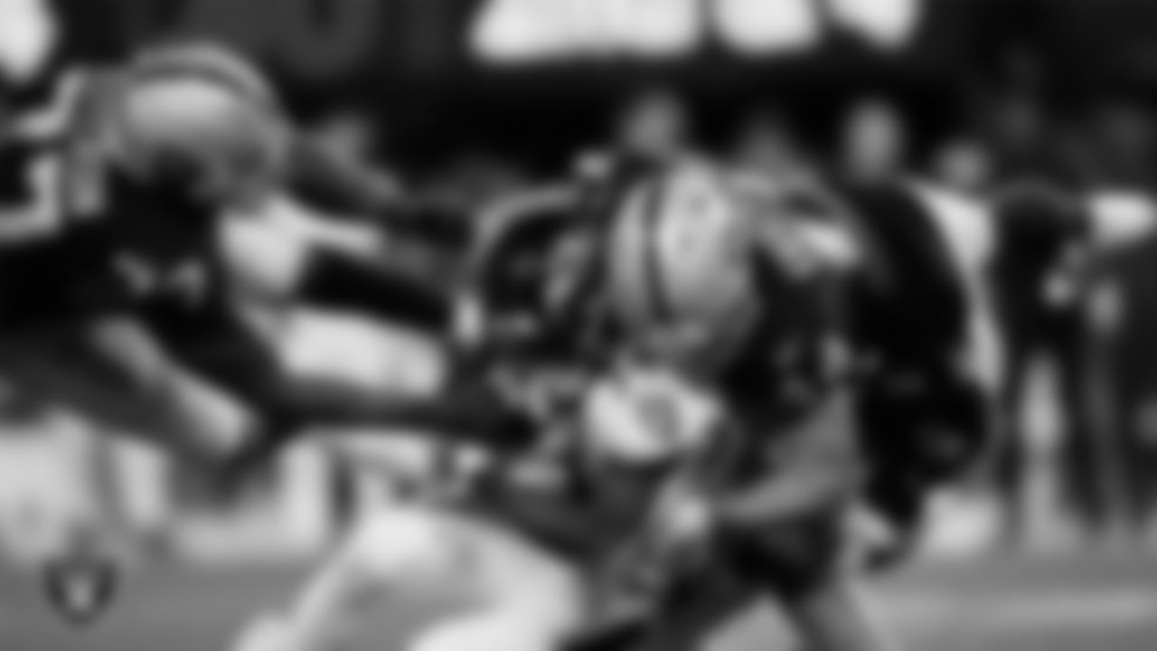 Las Vegas Raiders defensive tackle Quinton Jefferson (77) and linebacker Nick Kwiatkoski (44) make a tacke during the regular season home game against the Baltimore Ravens.