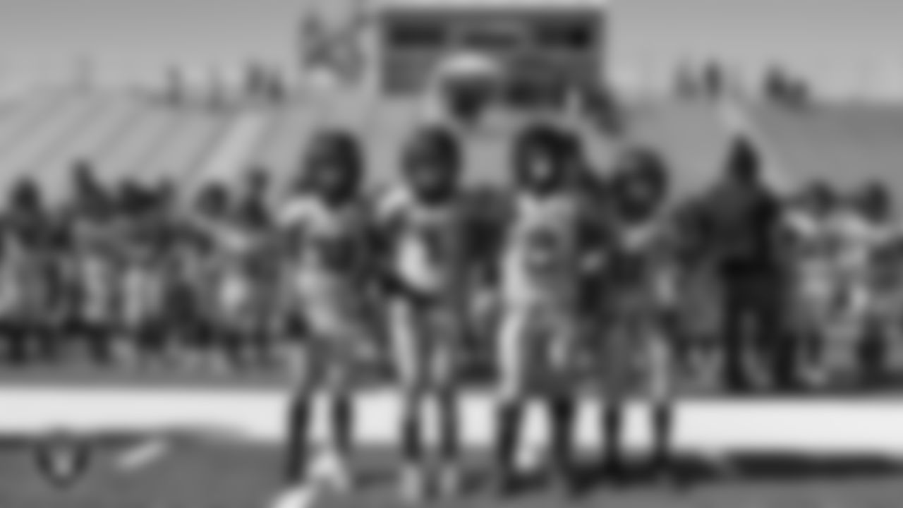 Team captains for the Apex Predators wait on the field for the coin toss during the American Youth Football & Cheer Regional Championships at Del Sol High School.