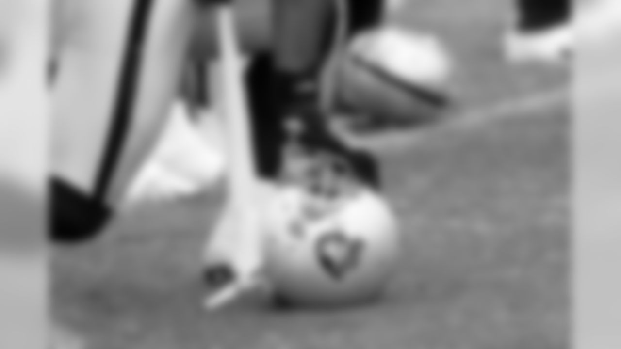 One Oakland Raider takes a knee on his helmet. Photo By Tony Gonzales