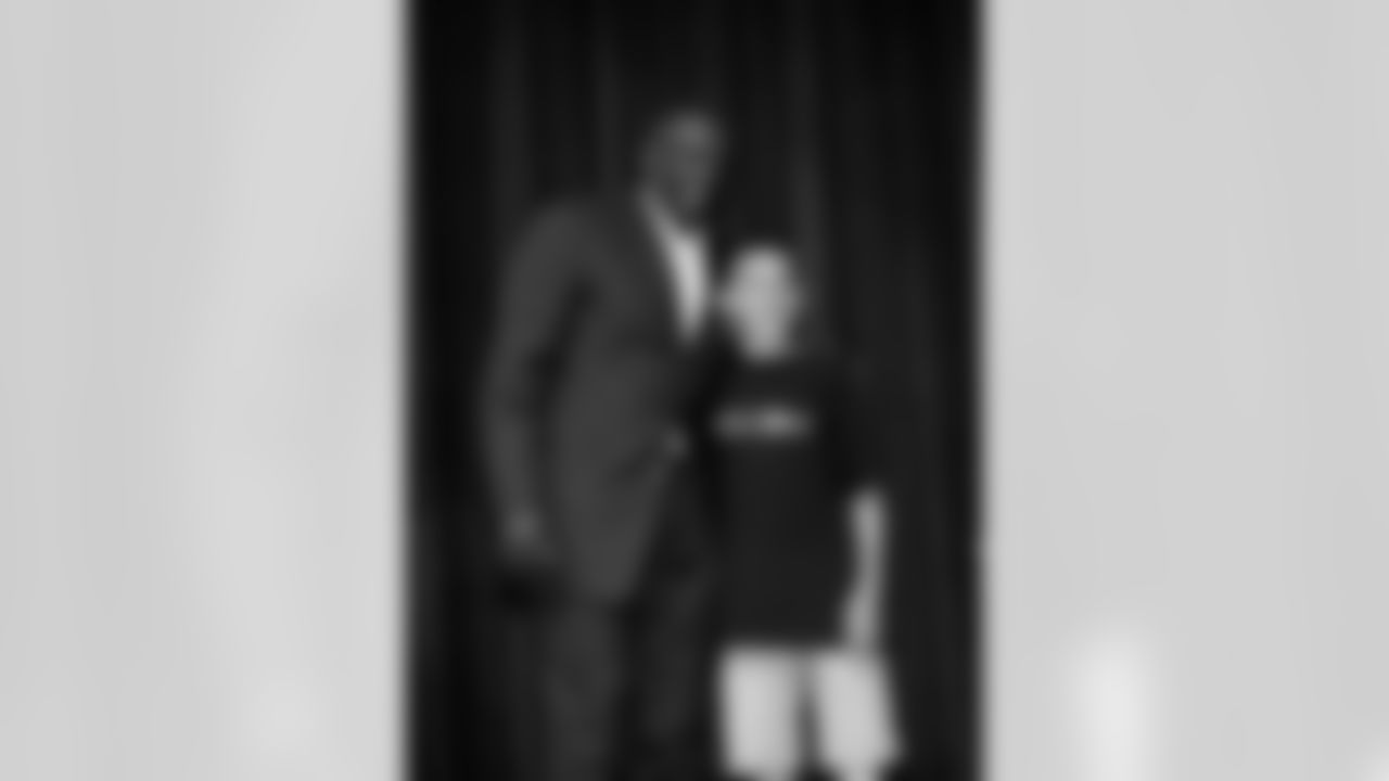 Tim Brown poses for a photo with a student.