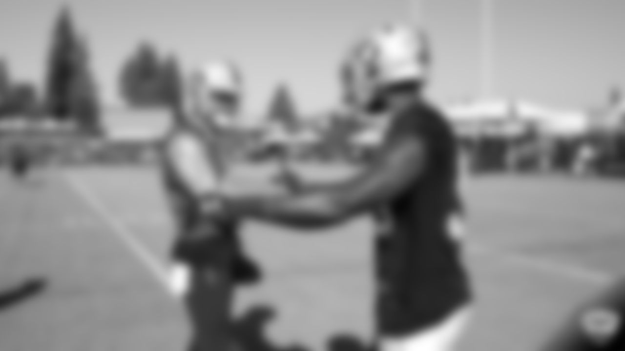 Oakland Raiders quarterback Derek Carr (4) and linebacker Tahir Whitehead (59) on the field for practice at 2019 Training Camp.