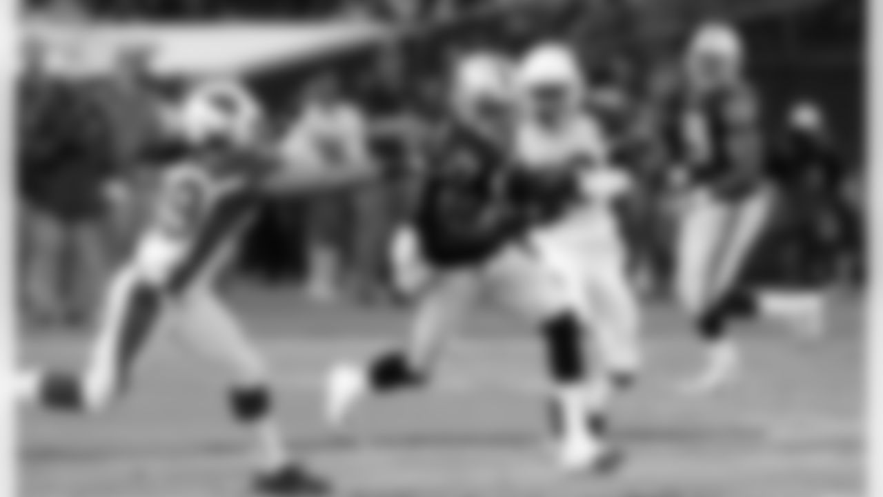 WR Denarius Moore slips through defenders and gains yards.