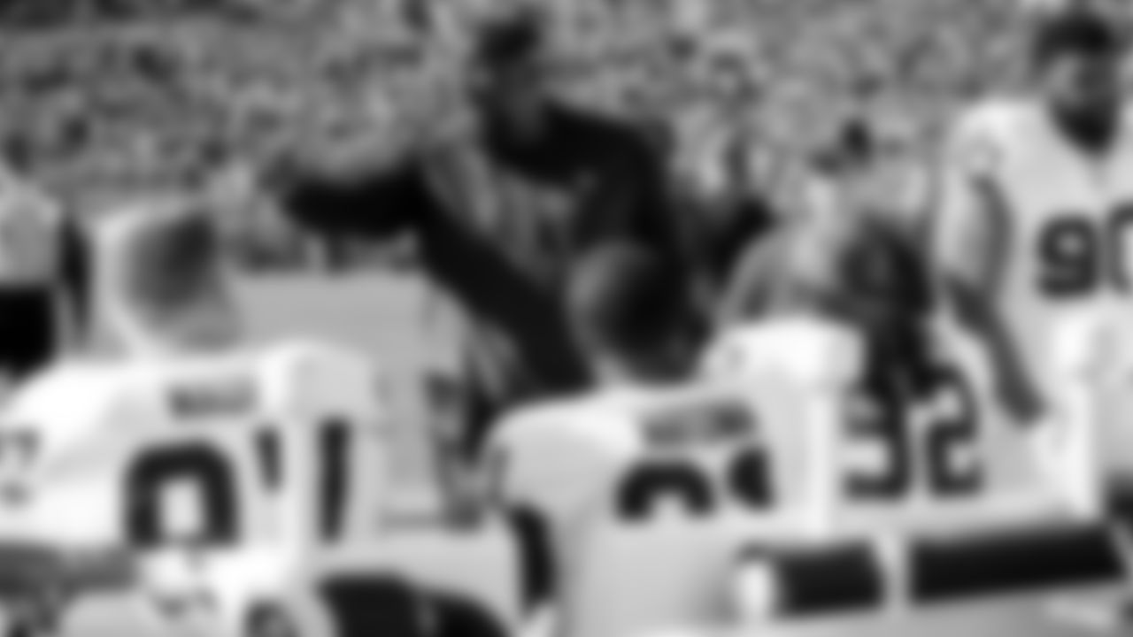 Raiders defensive line coach Brentson Buckner talks with the defensive line on the sideline during the regular season game against the Green Bay Packers.