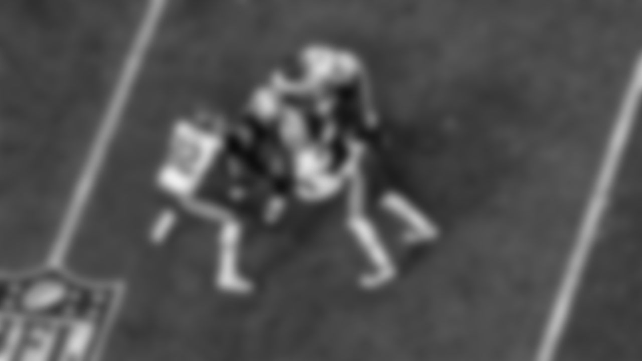 Las Vegas Raiders cornerback Nevin Lawson (26) and defensive end Arden Key (99) make a tackle during the regular season home game against the Kansas City Chiefs.