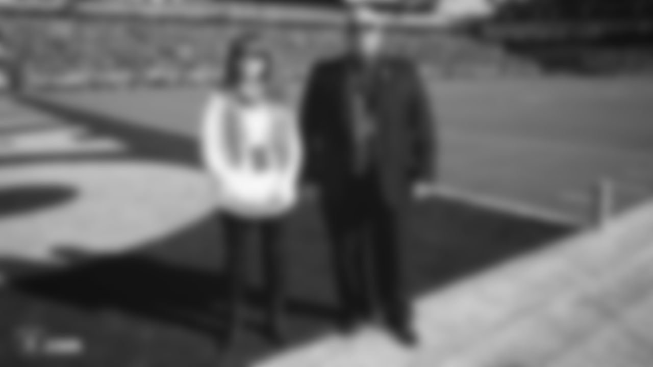 Raiders executive assistant to the owner Karen "Fudgie" Otten and vice president of security Dean Stavert are honored on the field during the Crucial Catch Stand Up Moment during the regular season game against the Detroit Lions.