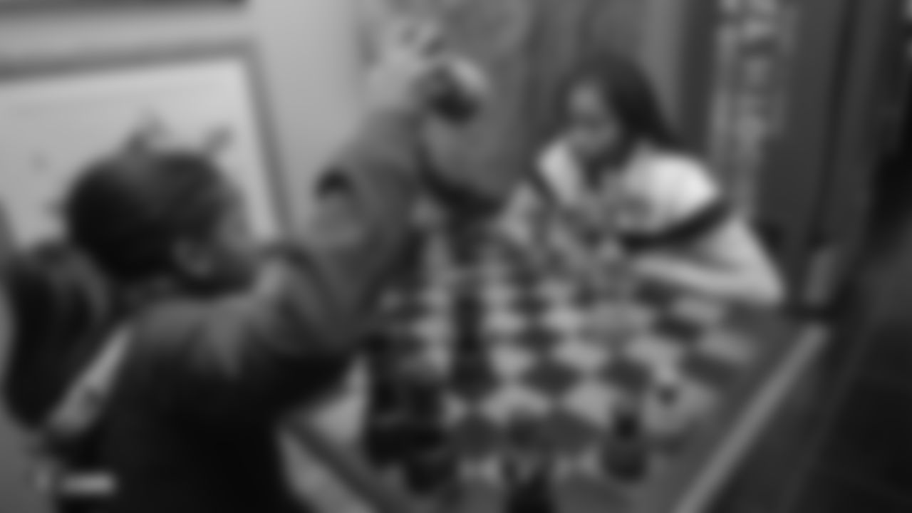 Attendees play chess at a Watch Party for members of the Las Vegas Raiders Family Association, troops from Nellis Air Force Base and their families during the Raiders regular season game against the New York Jets.