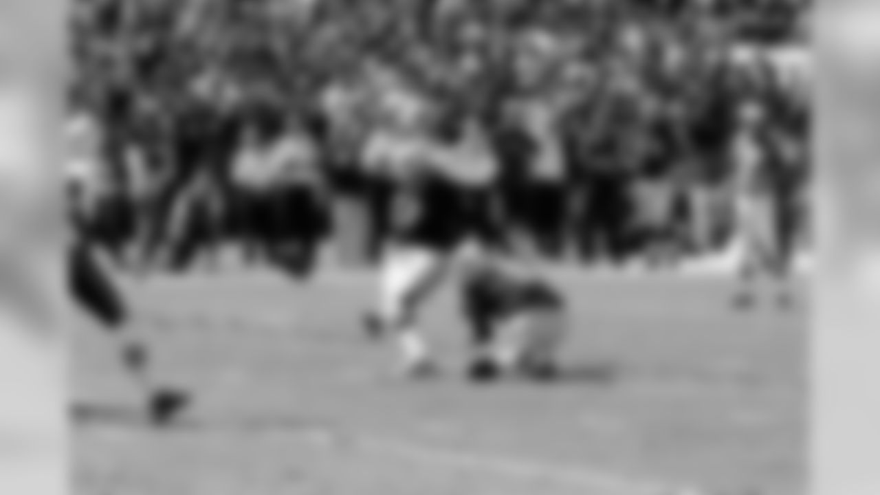 K Sebastian Janikowski kicks a field goal out of the hold of P Shane Lechler.