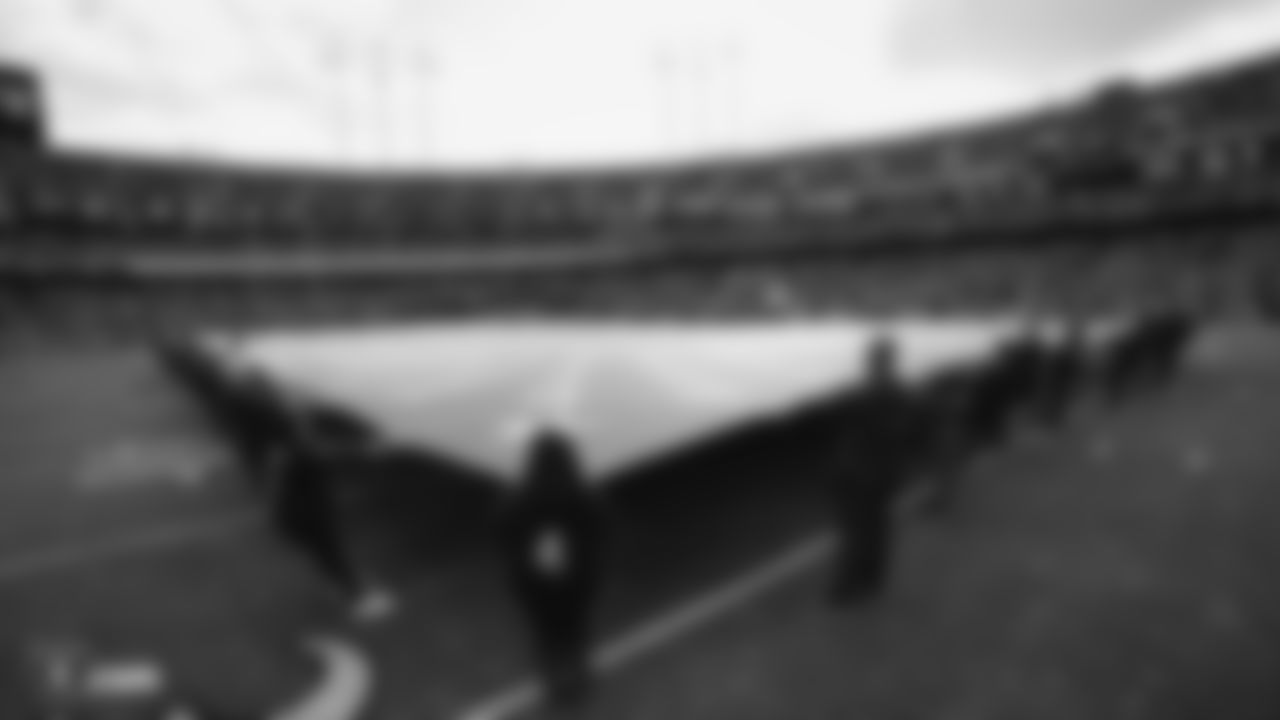 The American flag is displayed by season ticket members on the field during the national anthem before the Raiders regular season game against the Tennessee Titans.