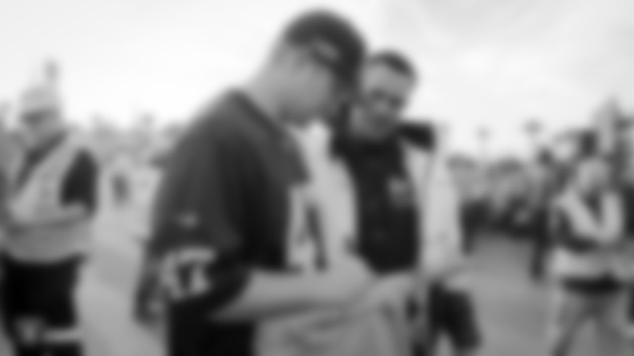 Raiders long snapper Trent Sieg (47) signs an autograph for a construction worker following an official announcement of the Raiders changing their name to the Las Vegas Raiders.