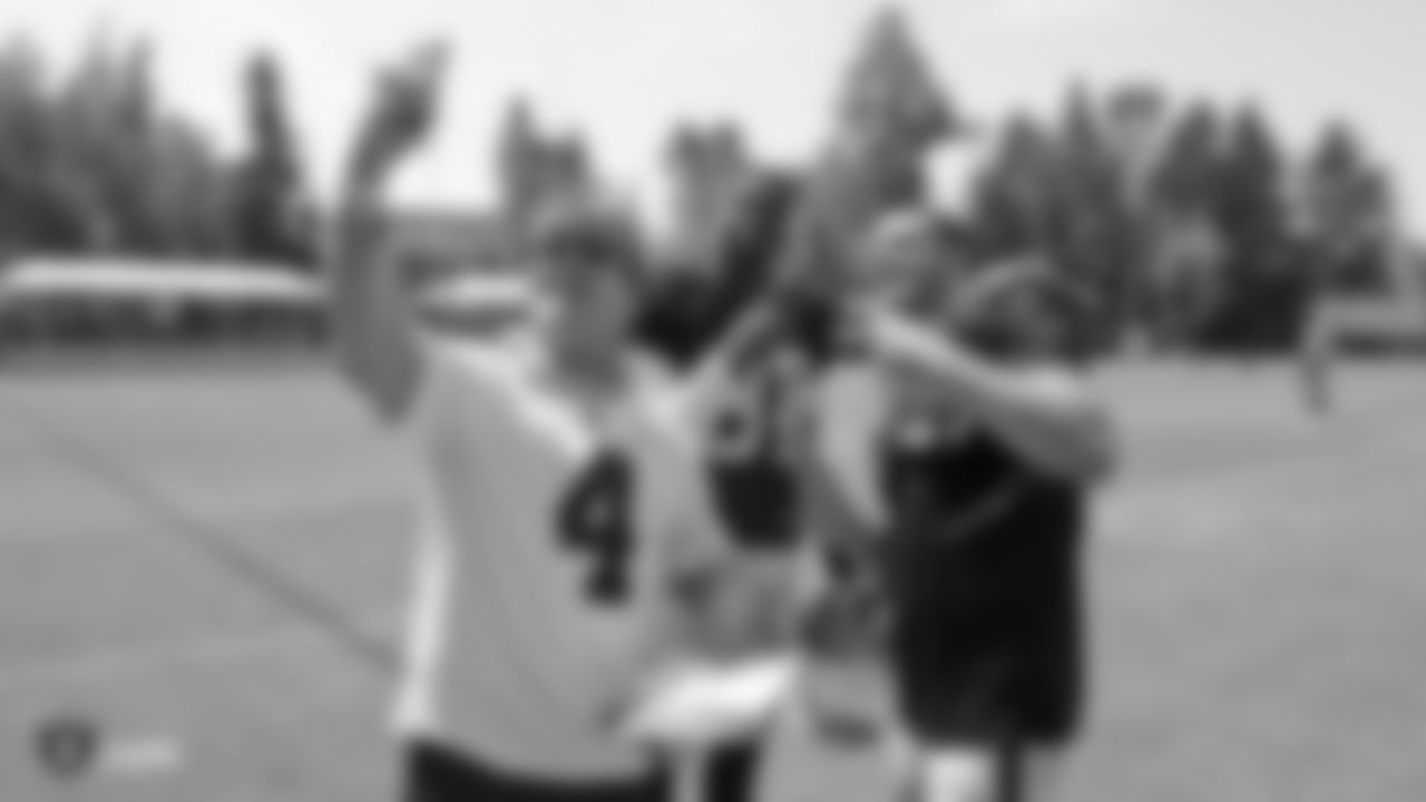 Oakland Raiders tight end Jared Cook (87) and quarterback Derek Carr (4) sign autographs for fans after practice at 2018 Training Camp at The Oakland Raiders Napa Valley Training Complex, Tuesday, August 14, 2018, in Napa, California.