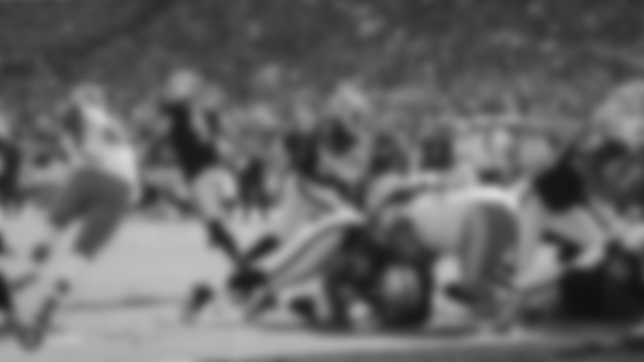 Raiders quarterback Derek Carr (4) hands the ball off to running back Josh Jacobs (28) during the regular season game against the Detroit Lions.