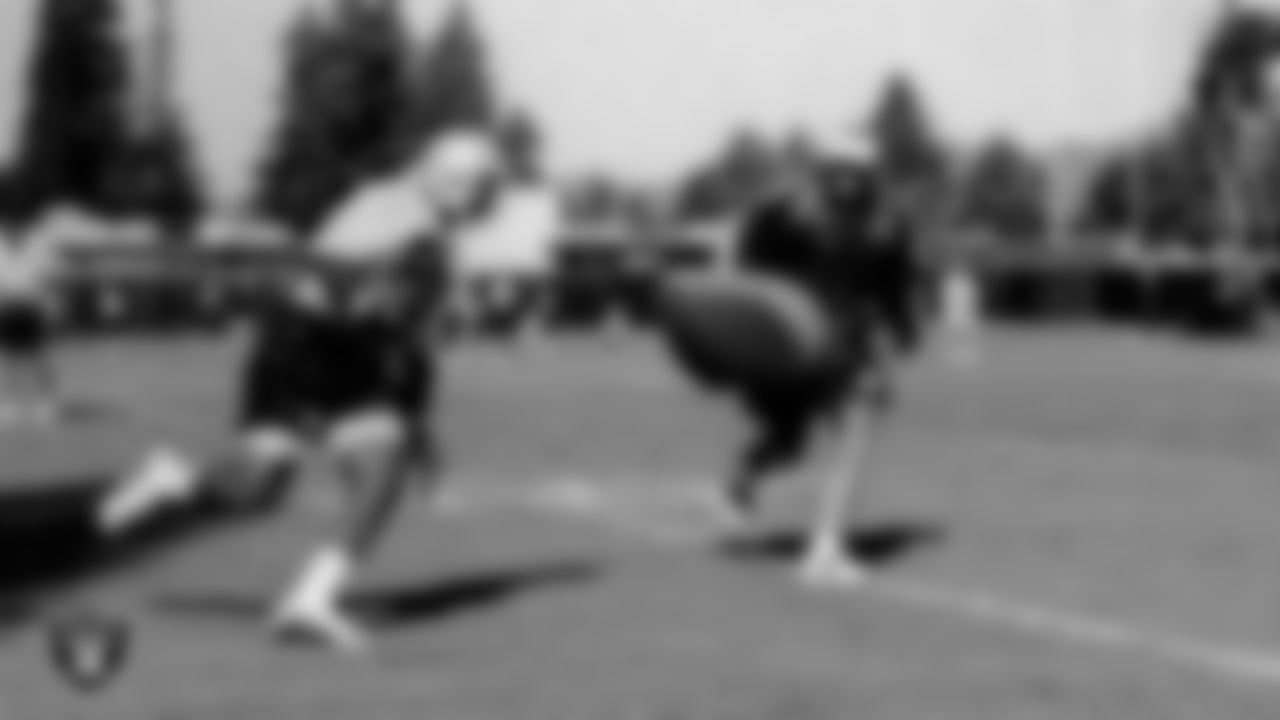 Raiders Head Coach Jon Gruden and wide receiver/kick returner David Dunn (84) on the field for practice at 2001 Training Camp.