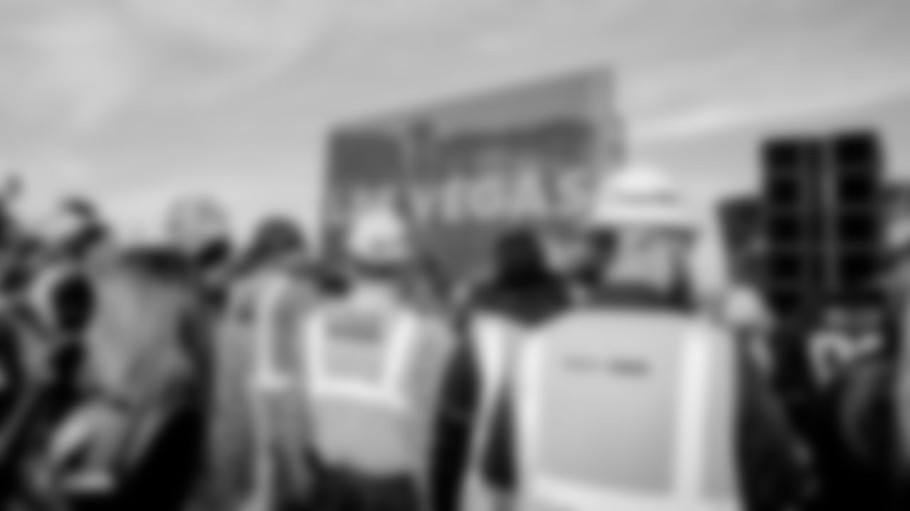 A Las Vegas Raiders sign in the background as construction workers line up to get players autographs following an official announcement of the Raiders changing their name to the Las Vegas Raiders.
