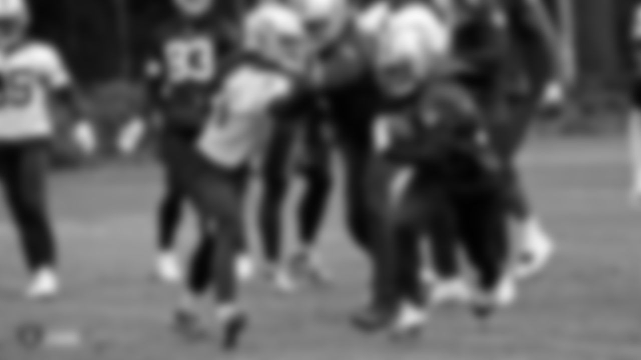 Raiders linebacker Dakota Allen (51) tries to stop running back DeAndré Washington (33) on the field during practice.