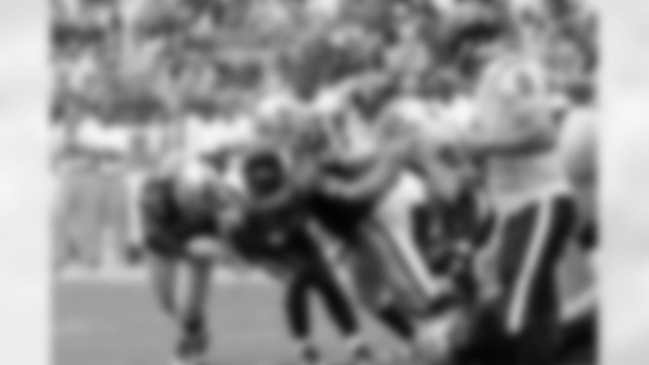 The Raiders defense wraps up the ball carrier.