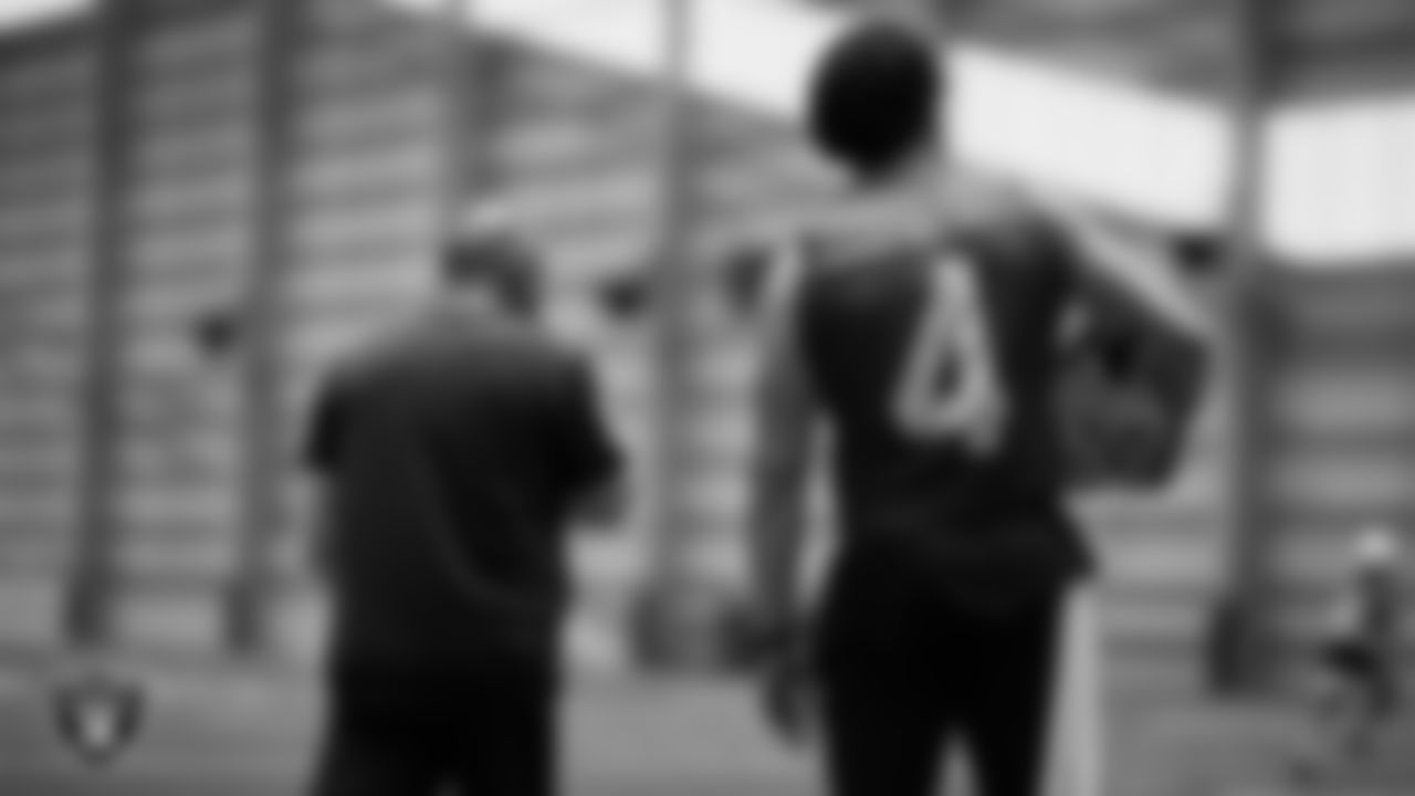 Las Vegas Raiders Interim Head Coach Rich Bisaccia and quarterback Derek Carr (4) during practice at Intermountain Healthcare Performance Center.