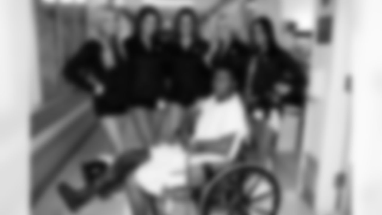 The Raiderettes signed this patient's cast and then posed for a photo. Photo by Tony Gonzales.