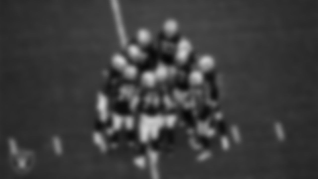 The Las Vegas Raiders offense huddle during the regular season home game against the Arizona Cardinals at Allegiant Stadium.