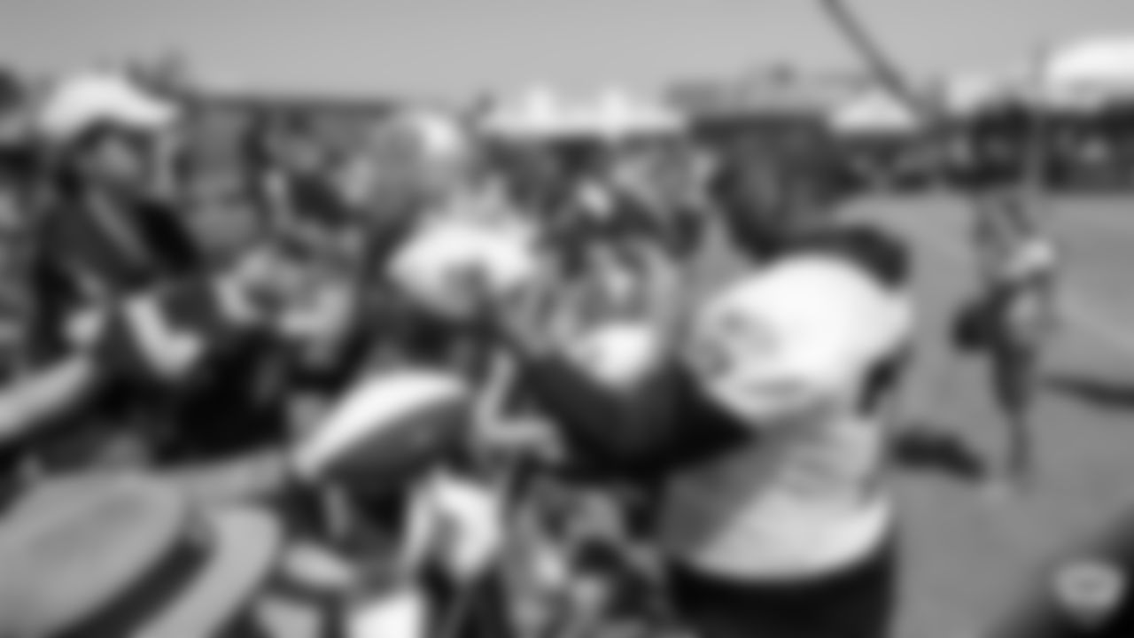 Oakland Raiders tackle Trent Brown (77) signs autographs for fans after practice at 2019 Training Camp.
