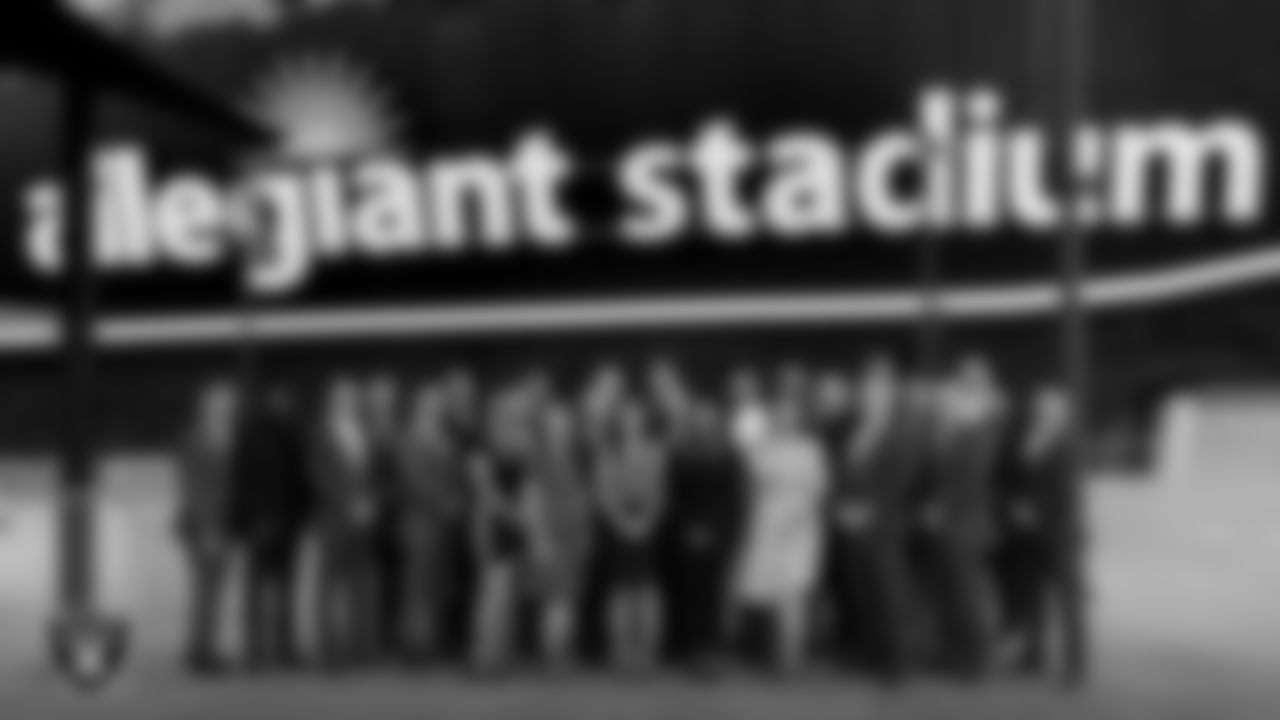 Las Vegas Metropolitan Police Department officers and officials pose for a photo in front of Allegiant Stadium.
