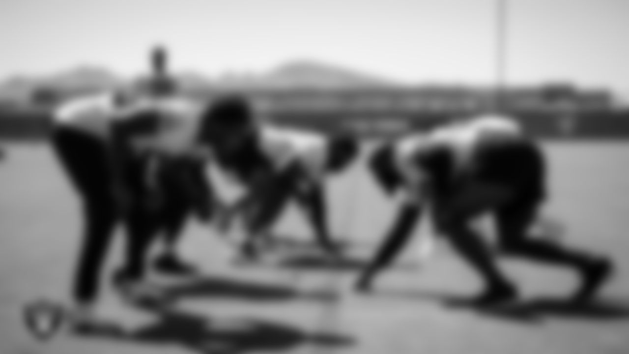 Las Vegas Raiders defensive linemen on the field during practice.