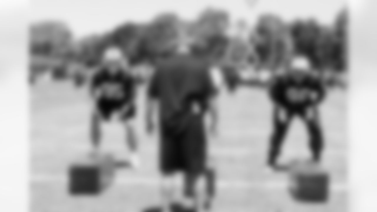 Defensive coordinator works with the defensive line.