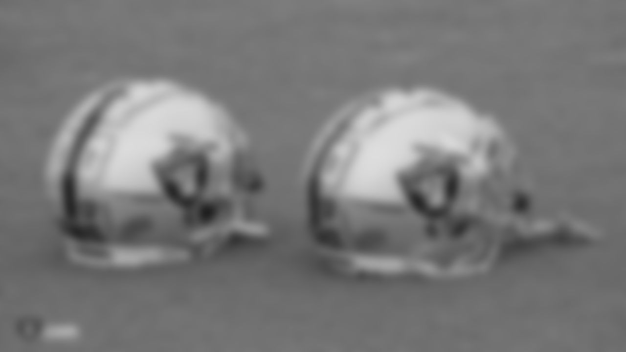 Raiders safety Curtis Riley's (35) and cornerback Dylan Mabin's (37) helmets on the field for practice.