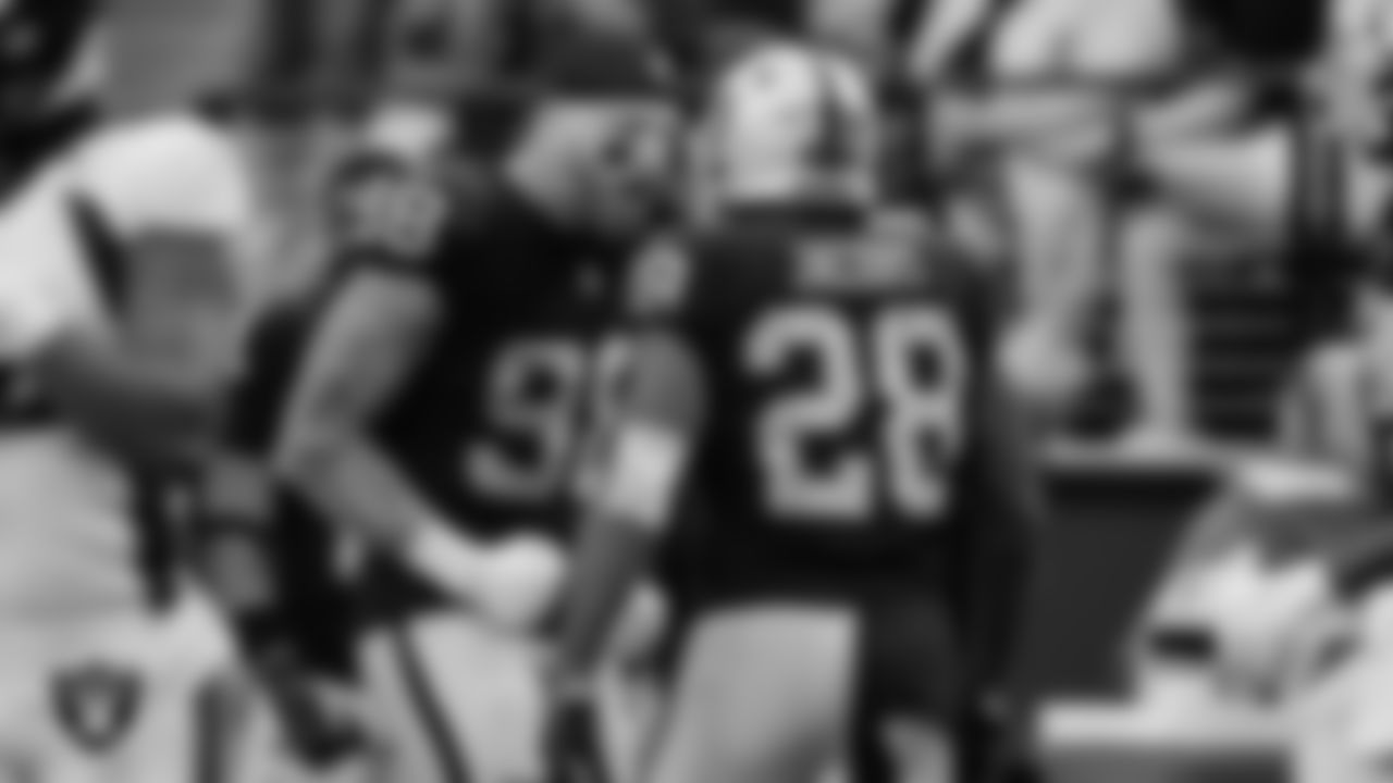 Las Vegas Raiders defensive end Maxx Crosby (98) and running back Josh Jacobs (28) during the regular season home game against the Denver Broncos at Allegiant Stadium.