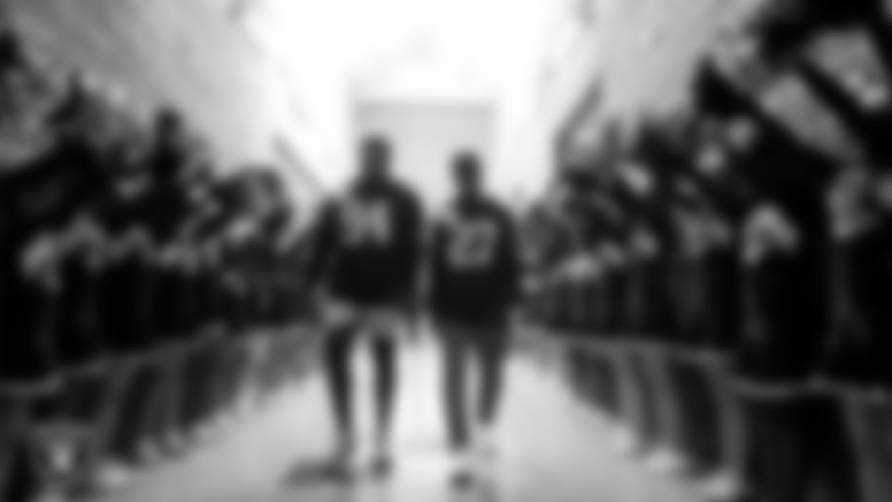 Las Vegas Raiders defensive tackle Matthew Butler (94) and cornerback Sam Webb (27) are greeted by the Grant Sawyer Middle School cheerleaders as they make their way to the Hip Hop & Entrepreneurship class, at Grant Sawyer Middle School.