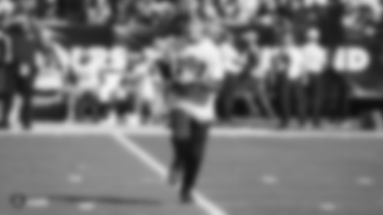 The Tee Grab participant retrieves the kicking tee after kickoff of the first quarter during the Raiders regular season game against the Detroit Lions.