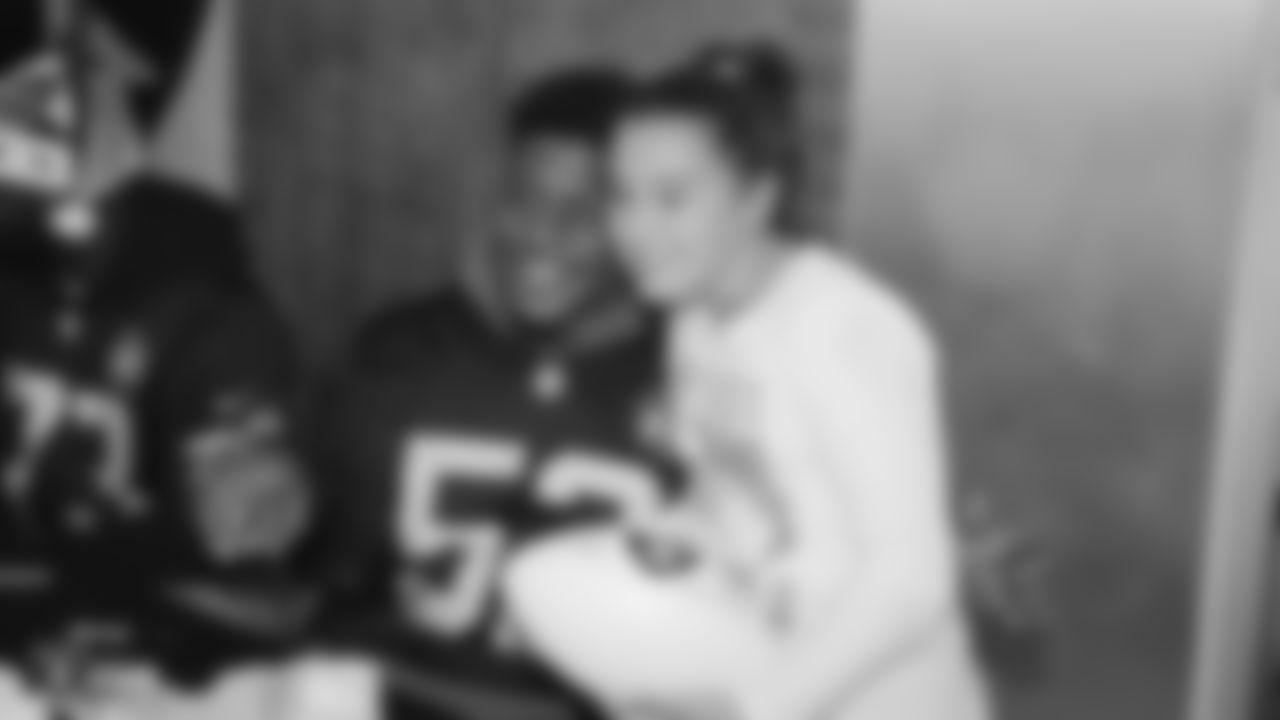 Raiders linebacker Marquel Lee (52) poses for a photo with a young fan during the Raiders Foundation's Toys for Tots drive.