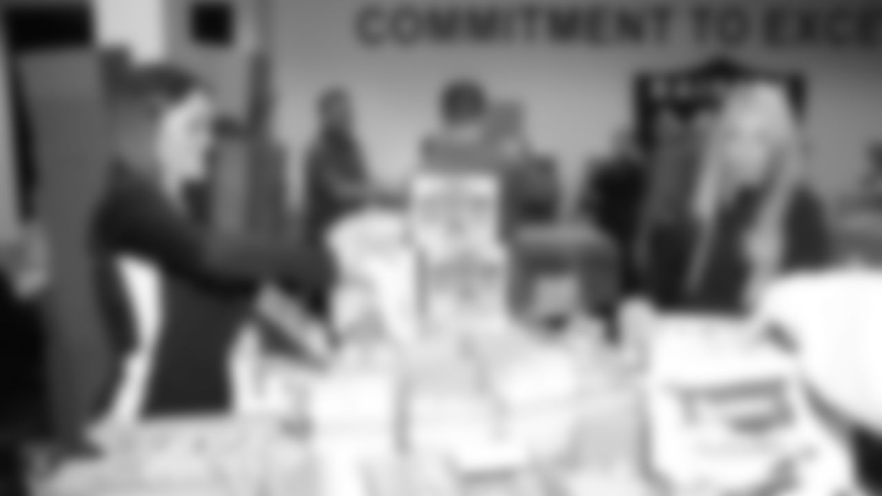 Oakland Raiders linebacker Kyle Wilber (58), tight end Paul Butler (84), tackle Jamar McGloster (64), defensive tackle Clinton McDonald (97), linebacker Shilique Calhoun (91), long snapper Andrew DePaola (48), the Raiderettes, and the Raiders Front Office in Alameda build care packages for victims of the Norther California Fires, Tuesday, November 20, 2018, in Alameda, California.