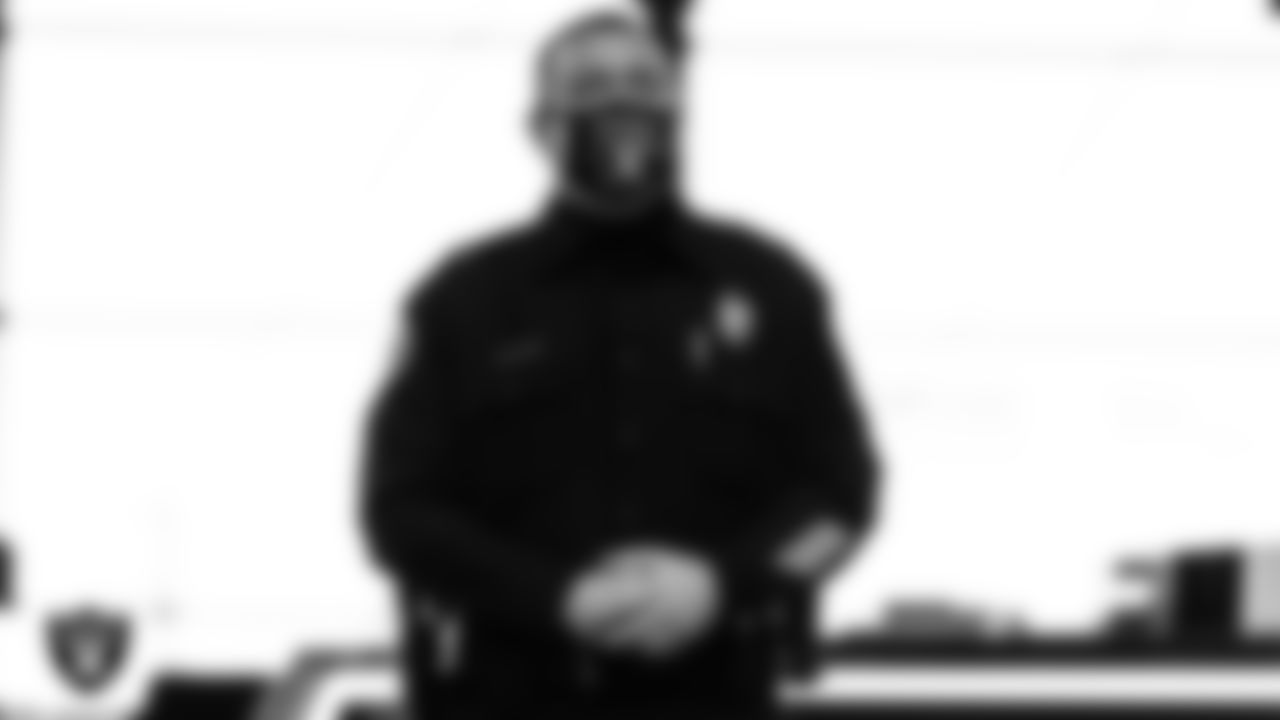 A member of the Las Vegas Metropolitan Police Department waits to light the Al Davis Memorial Torch before the Las Vegas Raiders regular season home game against the Indianapolis Colts.