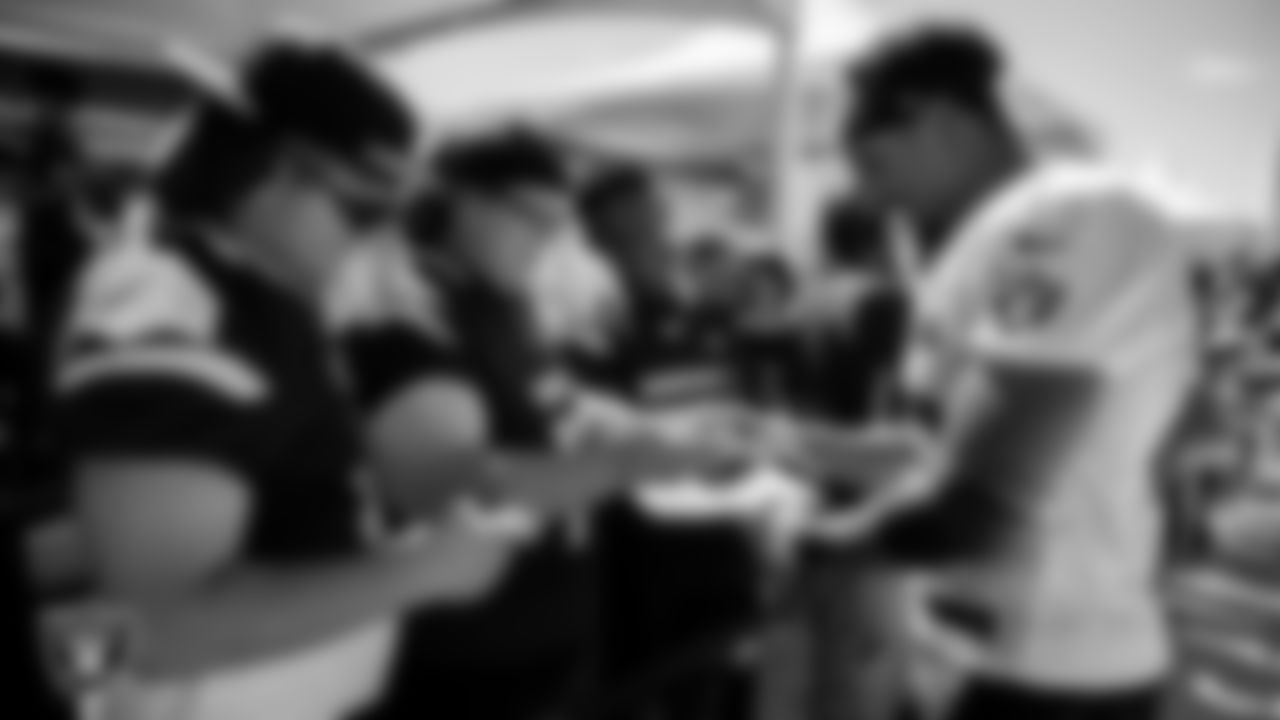 Las Vegas Raiders fullback Jakob Johnson (45) signs autographs for members of the Eldorado High School football team at 2022 Training Camp at Intermountain Healthcare Performance Center.
