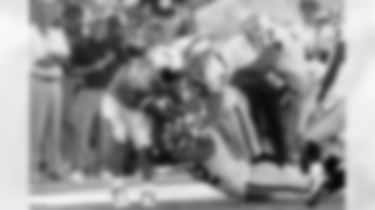 Raiders defenders led by DE Richard Seymour (92) and S Tyvon Branch (33) put the brakes on RB LaDainian Tomlinson.