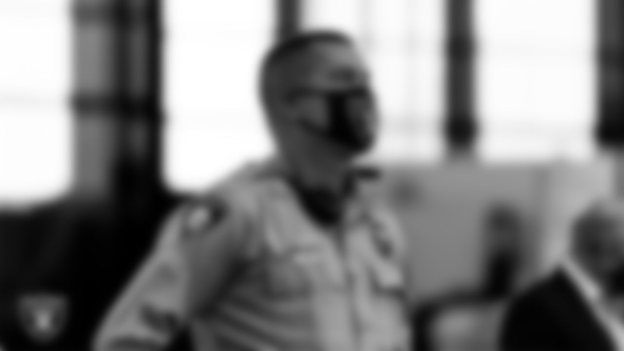 A member of the Las Vegas Metropolitan Police Department waits to light the Al Davis Memorial Torch before the Las Vegas Raiders regular season home game against the Indianapolis Colts.