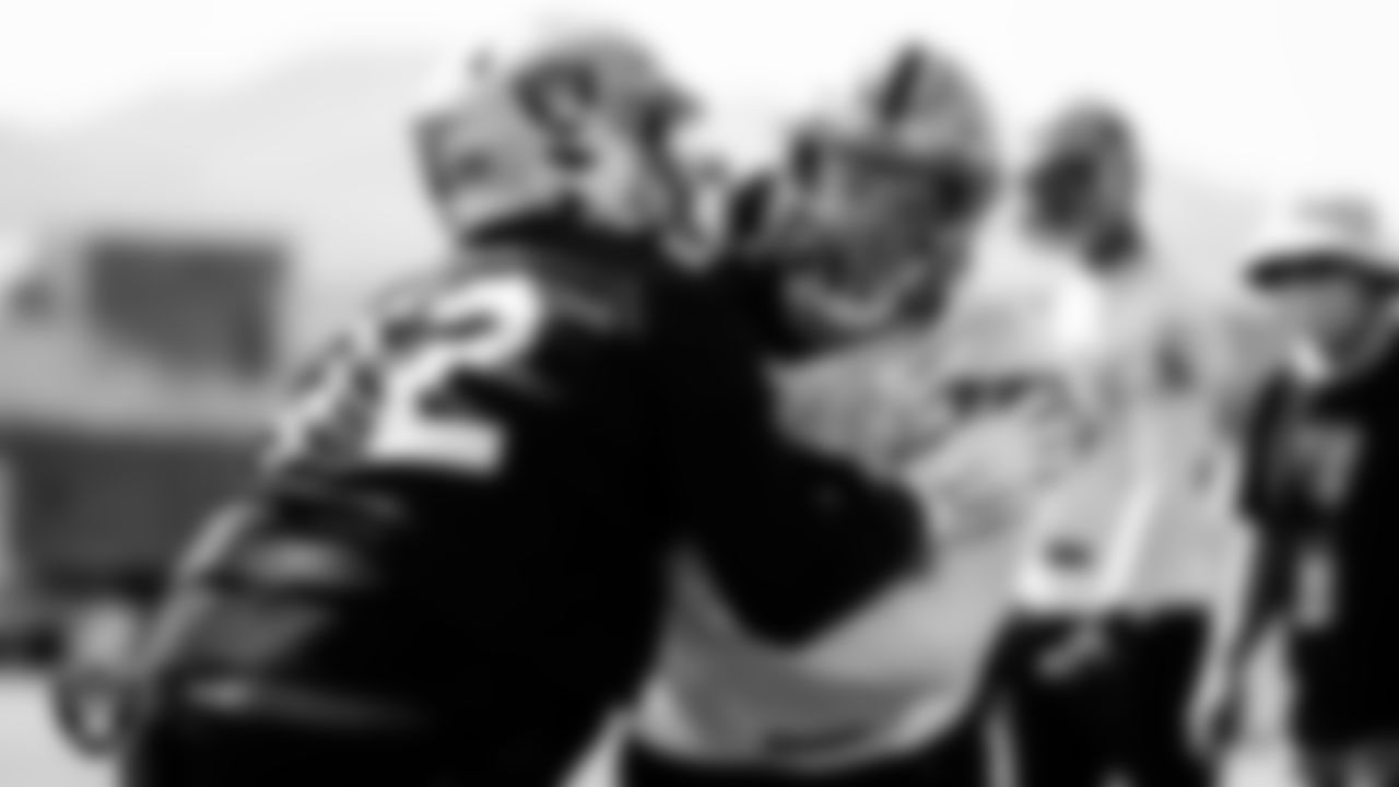 Las Vegas Raiders offensive lineman Jaryd Jones-Smith (72) and defensive end Maxx Crosby (98) during practice.