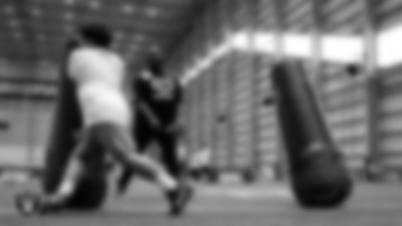 Las Vegas Raiders defensive lineman Neil Farrell Jr. (92) works with an athlete as they participate in drills during the ELITE Academy at Las Vegas Raiders Headquarters.